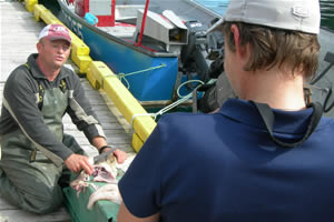 Amy filming cod fisherman in Newfoundland